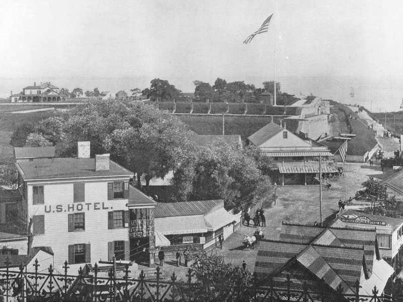 A black and white photograph of the Harbor Defense Museum and the surrouding area.